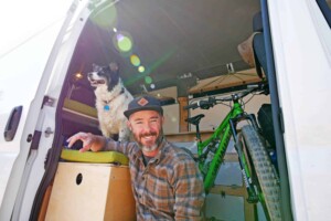 man with dog in camper van