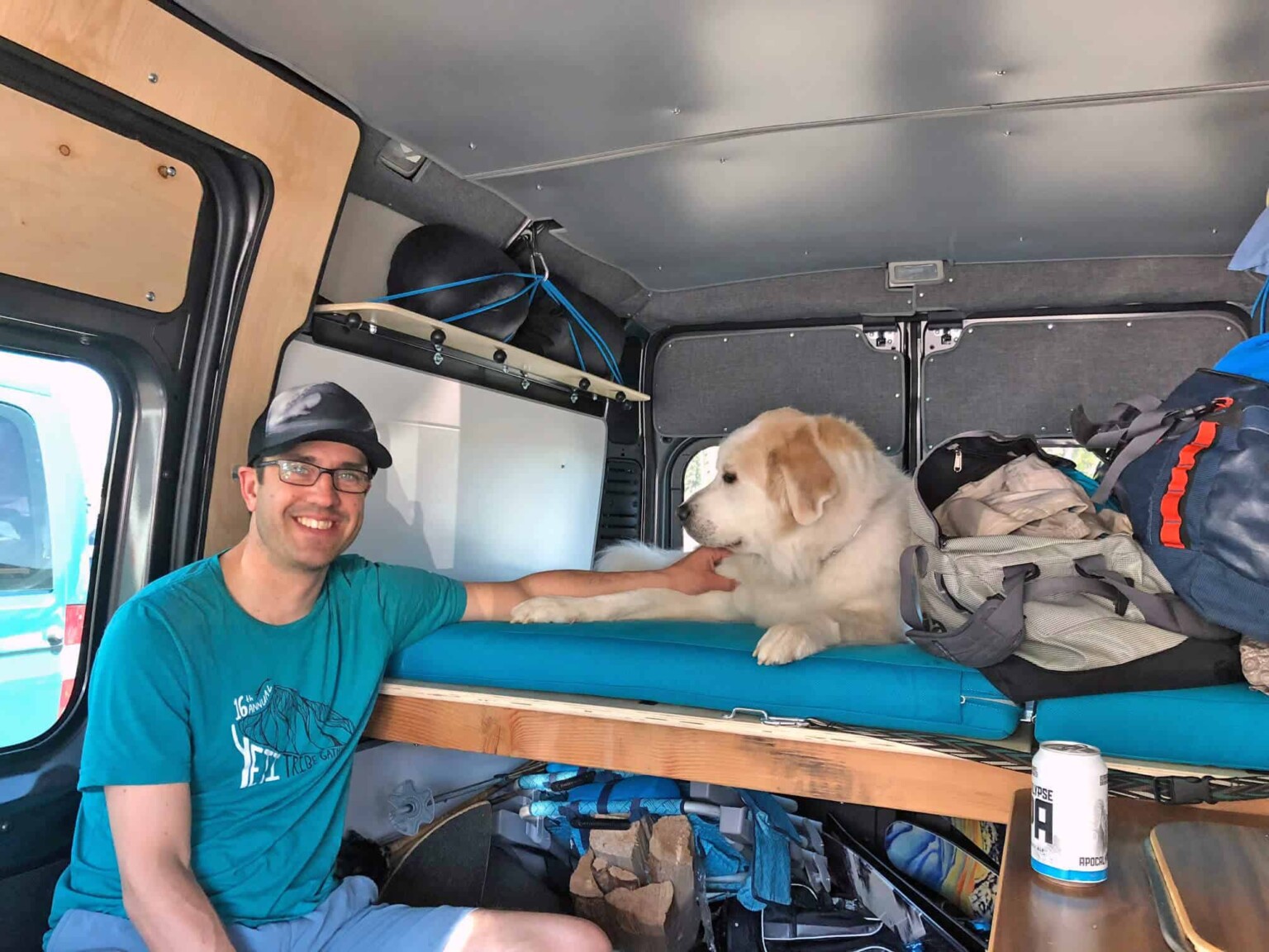 happy client andy with dog inside camper van