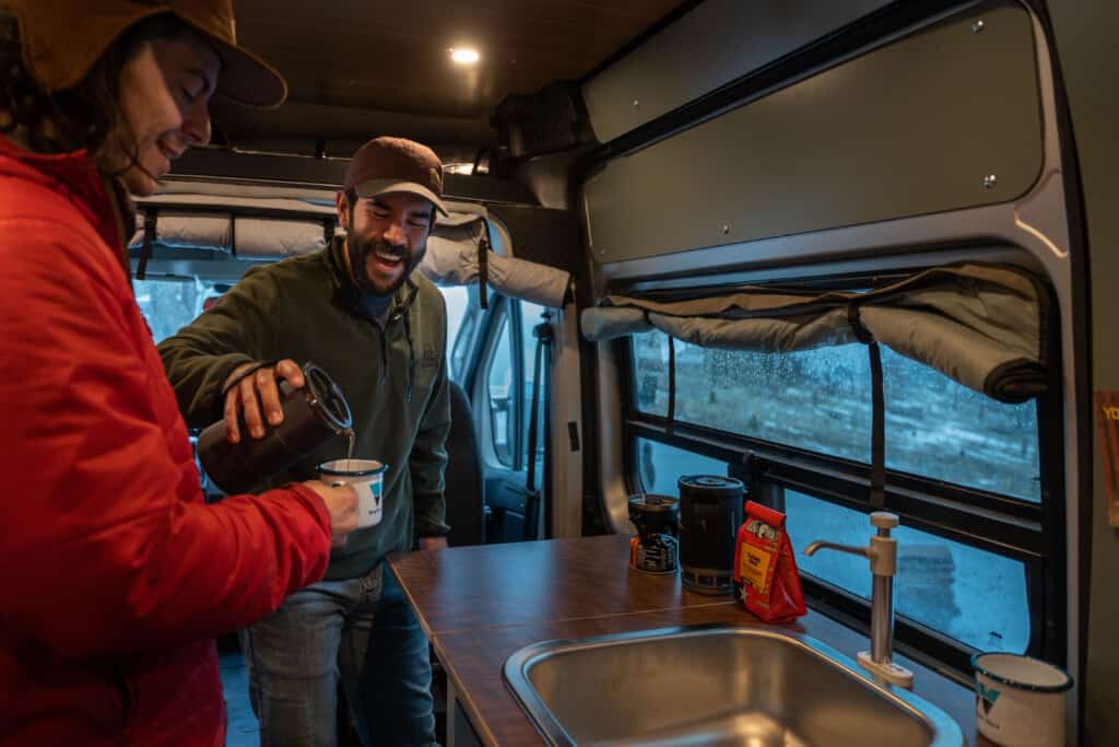 enjoying coffee inside a camper van conversion