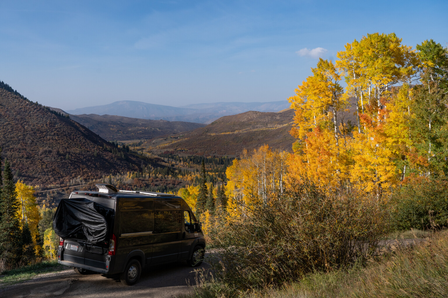 Wayfarer Vans conversion overlooking vista with changing Aspen trees all around